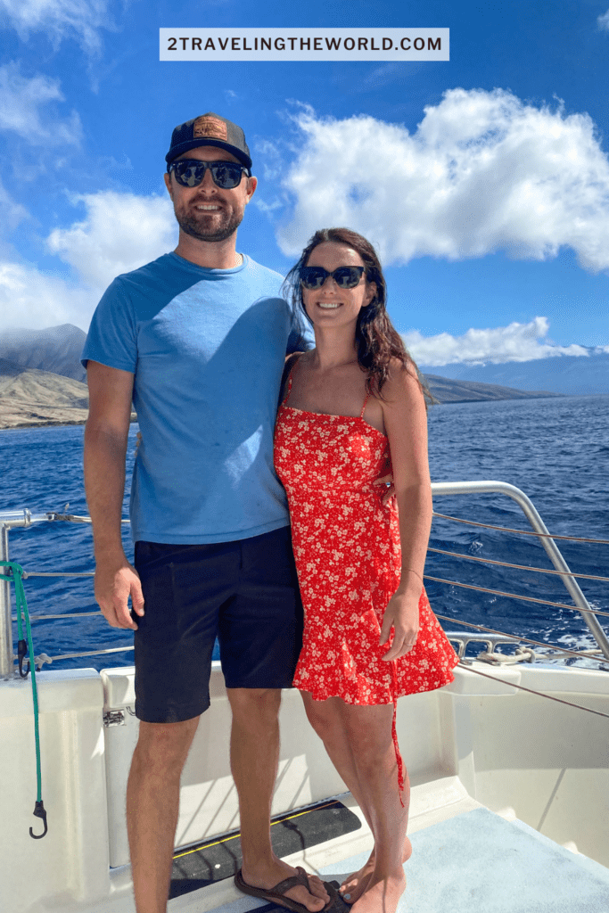 maui snorkel beaches. This image shows jordyn and michael from 2 traveling the world standing on a boat on their way to find the best snorkel beaches in Maui. The tours we went on all were focused around places to swim with turtles in maui.