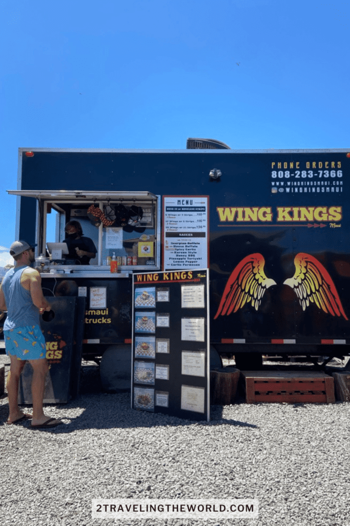 things to do in kihei food trucks. man standing at the wing kings food truck in maui. his back is turned toward the camera.