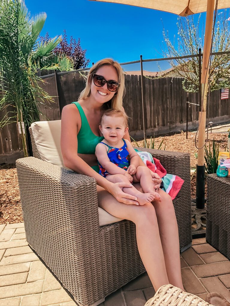 mom holding baby in the sun and sharing best natural sunscreens for babies