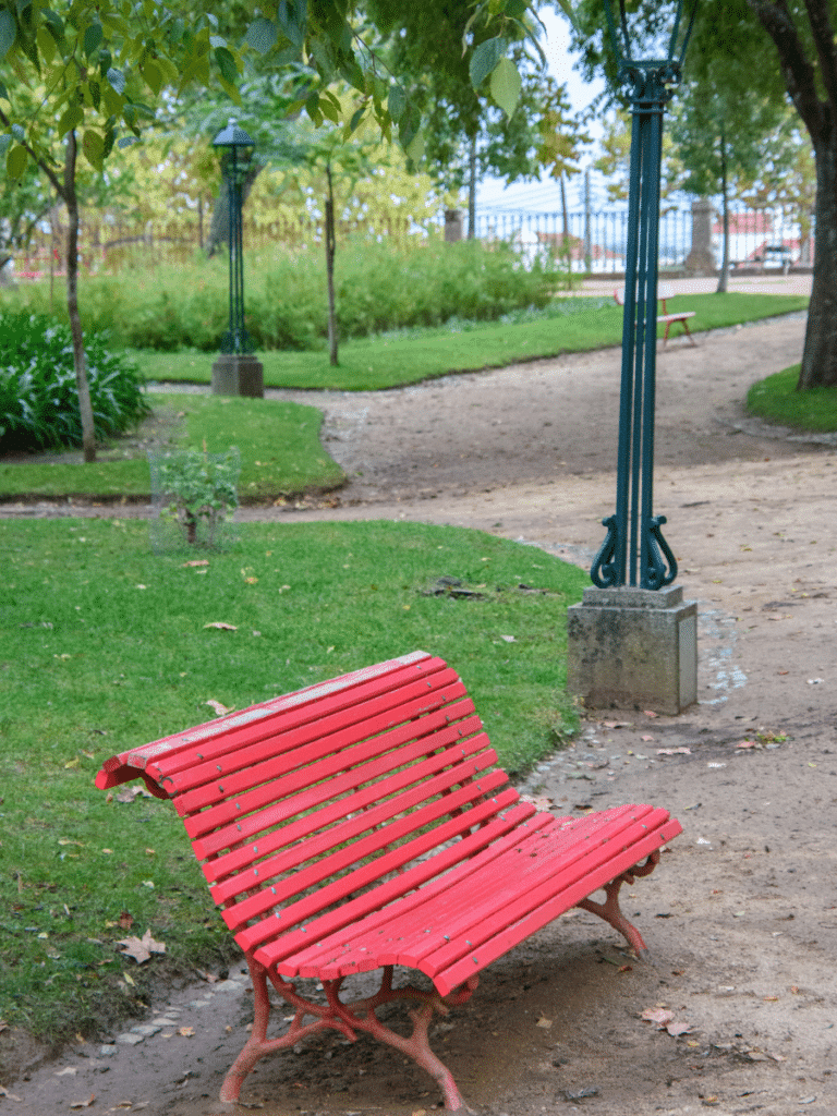 red park bench in the évora Portugal alentejo region public garden
