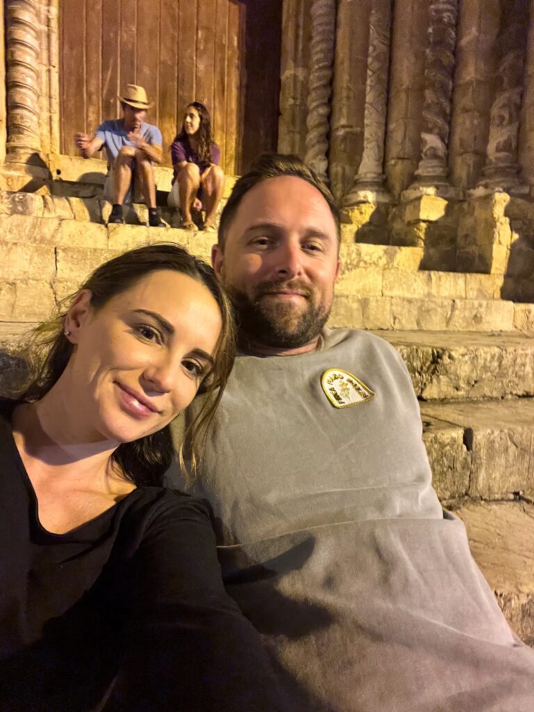 Jordyn and Michael sitting on steps as University students host music concerts to share Fado throughout the charming town of Coimbra