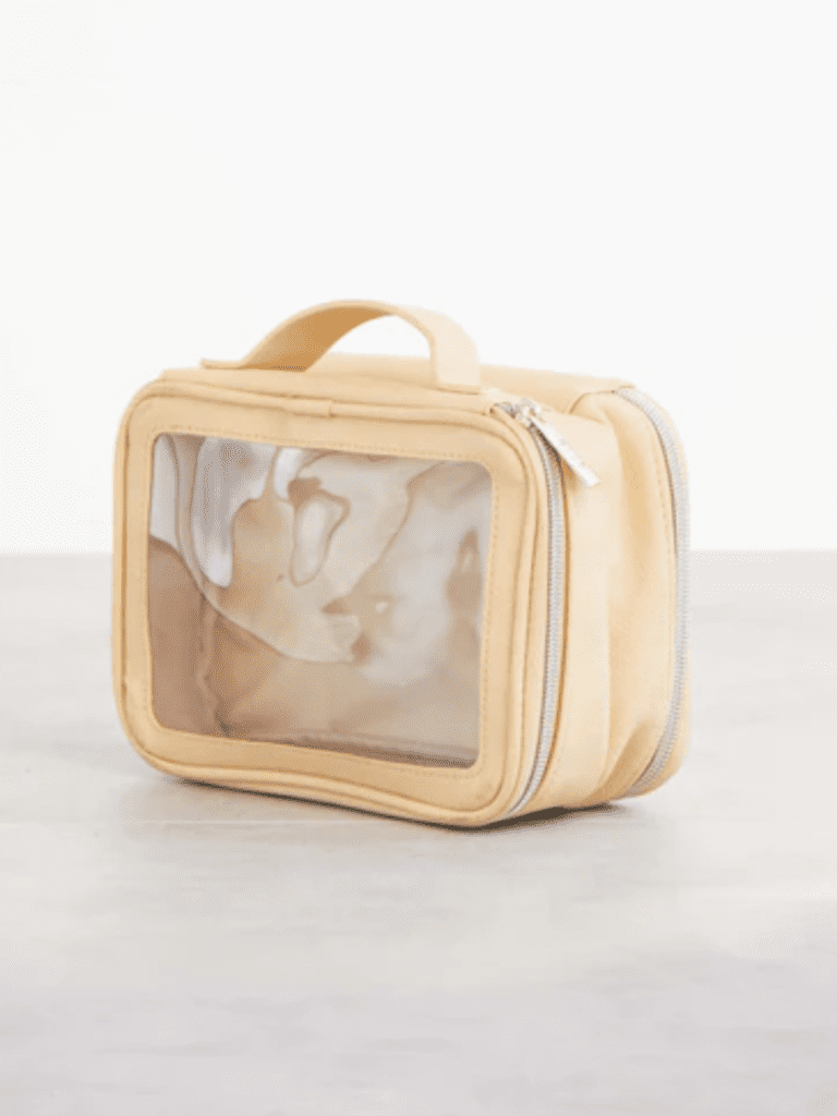 Favorite travel products by Beis. sturdy Clear makeup bag in tan with plastic on front and can fit in your favorite weekender bags