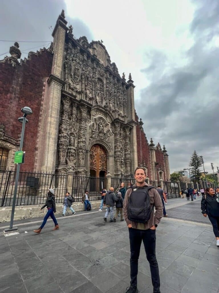 Man standing in front of the Metropolitan Cathedral in downtown Mexico CityMan standing in front of the Metropolitan Cathedral in downtown Mexico City