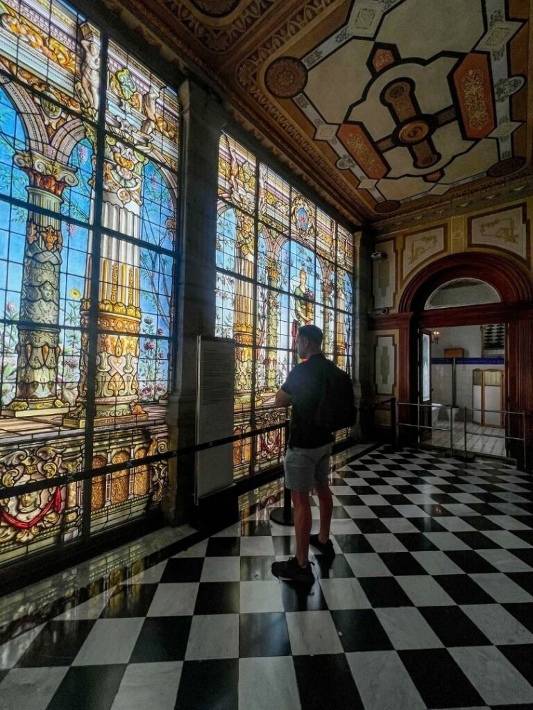 Man standing inside a stain glassed window inside the Chapultepec Castle in Mexico City