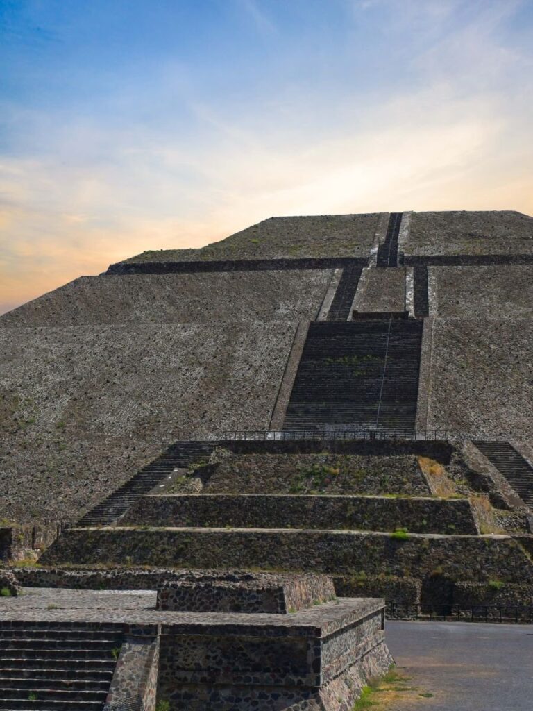 Teotihuacan tours from Mexico City. Woman standing in front of Pyramid of the Sun during herSan Juan Teotihuacan tour
