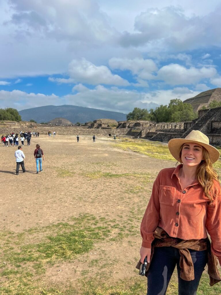 woman standing in front of the Mexico City Pyramids with her tour guide