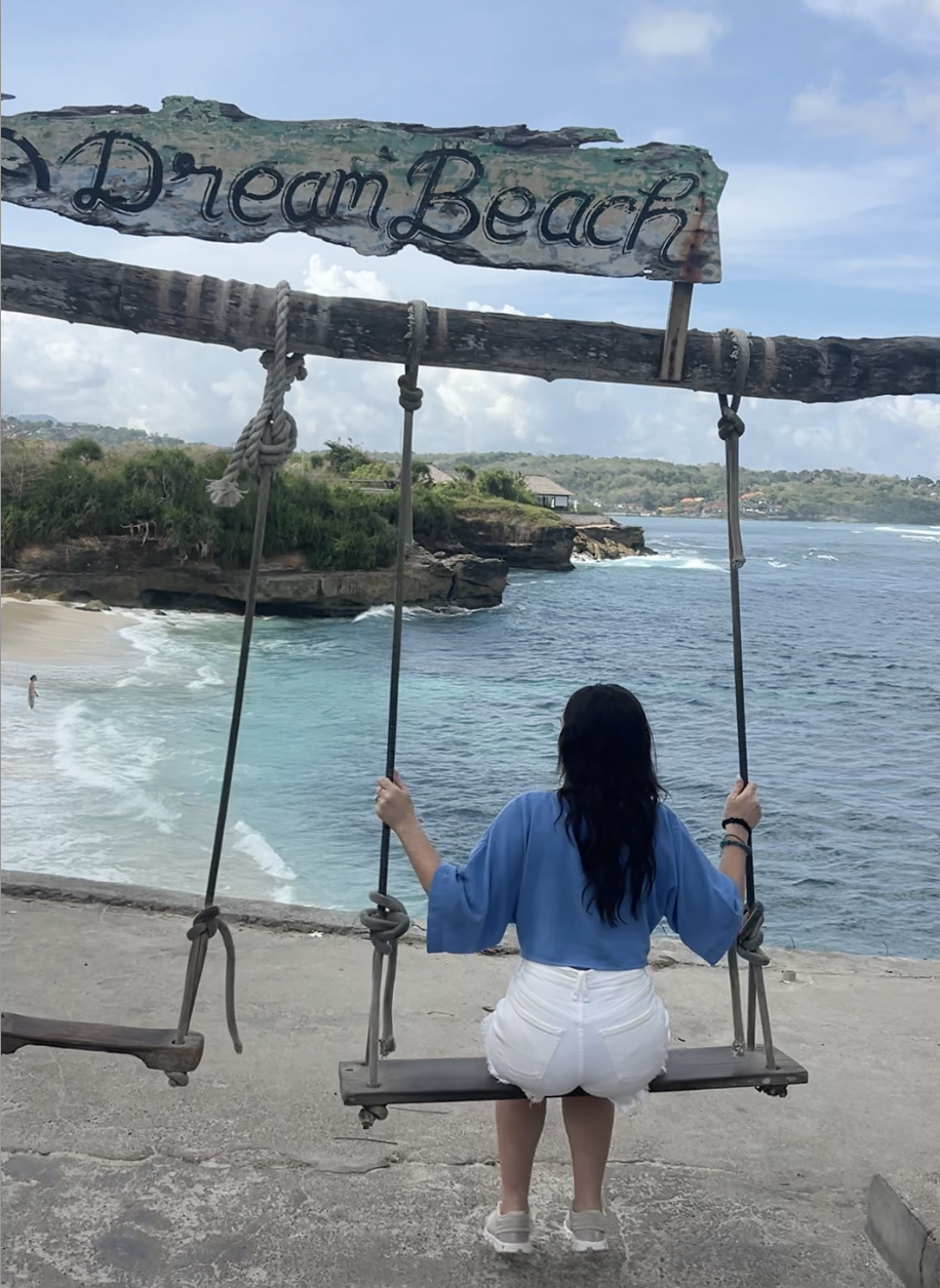 Jordyn from 2TravelingTheWorld at Dream beach swings as part of our 10 day Bali Itinerary