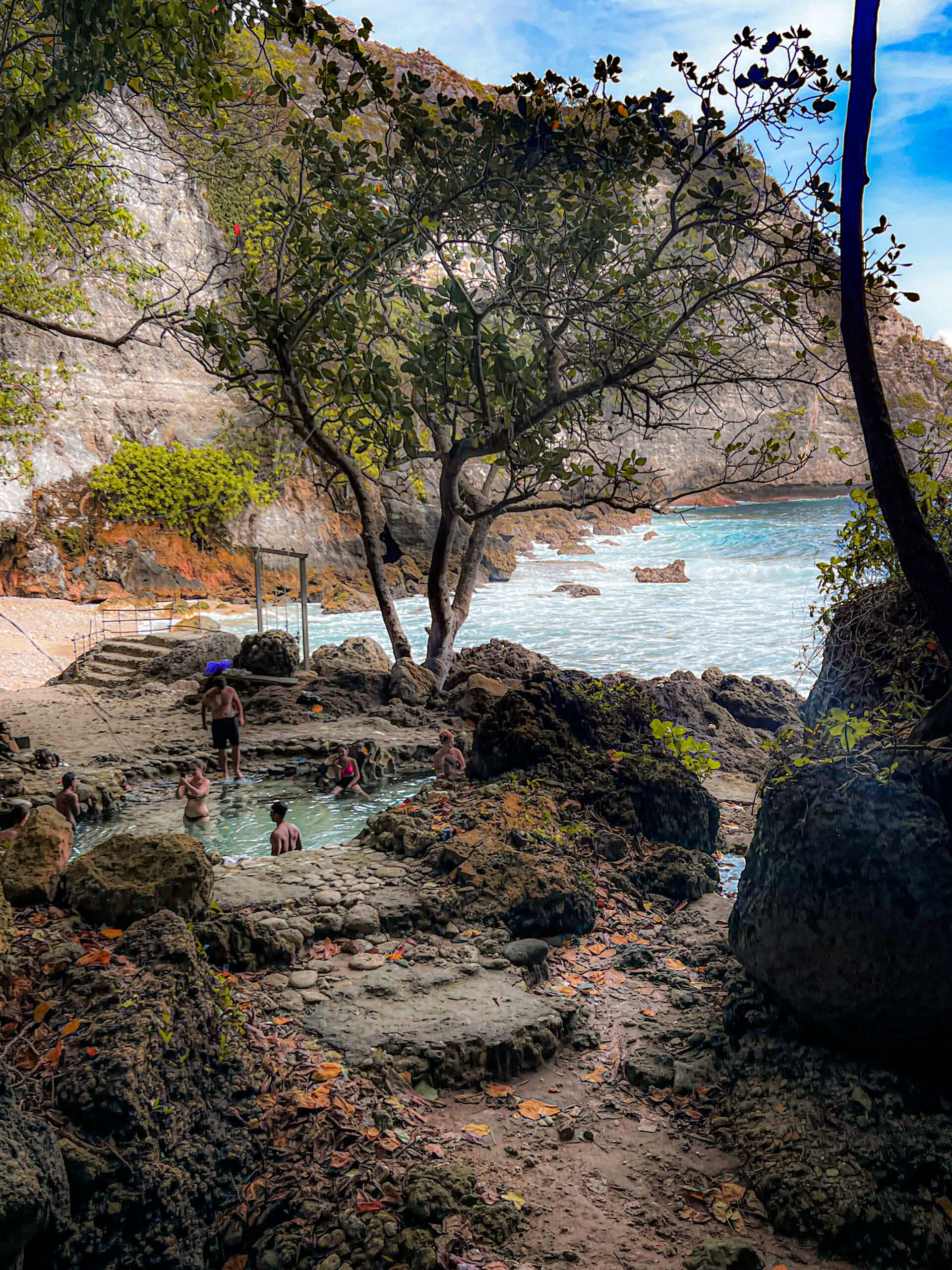 People swimming at Tembling Beach, a secret beach and watering hole on Nusa Penida