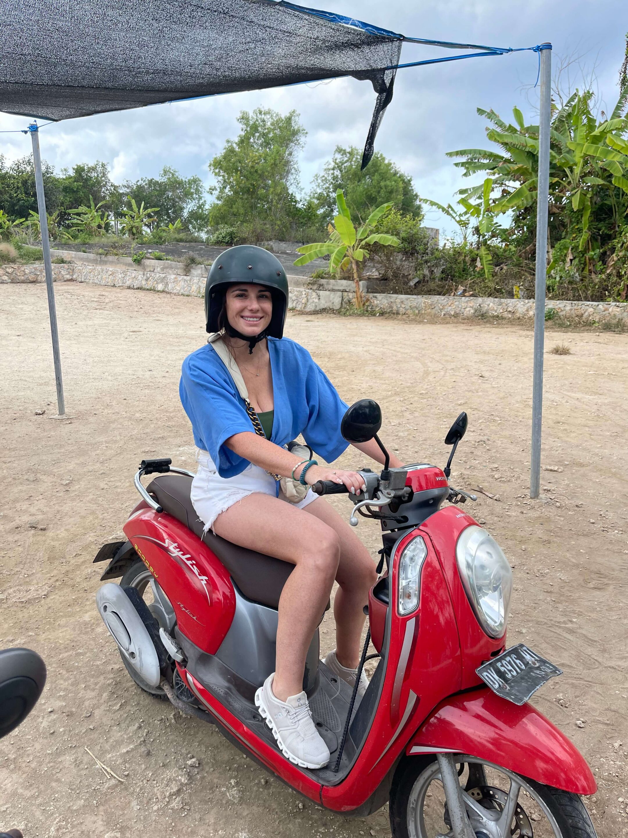 Woman on motor bike exploring Nusa Lembongan