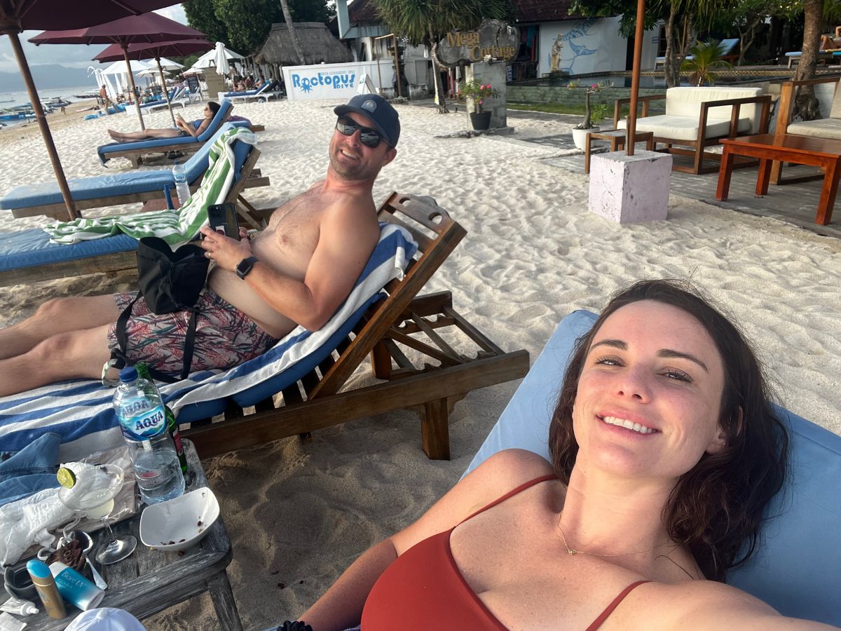 woman and man lounging on the beautiful island of Nusa Lembongan at one of the islands most affordable hotels, Mega Cottages