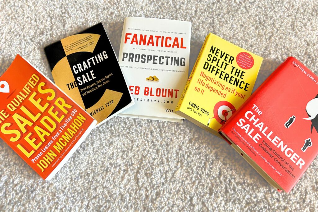 Image of 4 books on the floor that all teach modern sales techniques that all sales professionals can use to build an effective sales strategy